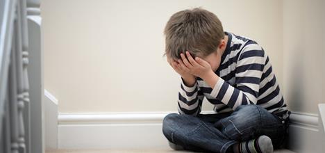 Sad or worried child sitting on the steps