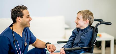 a person talking to a person in a wheelchair