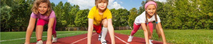 a group of children running on a track